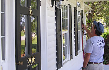 A specialist treats a front porch 